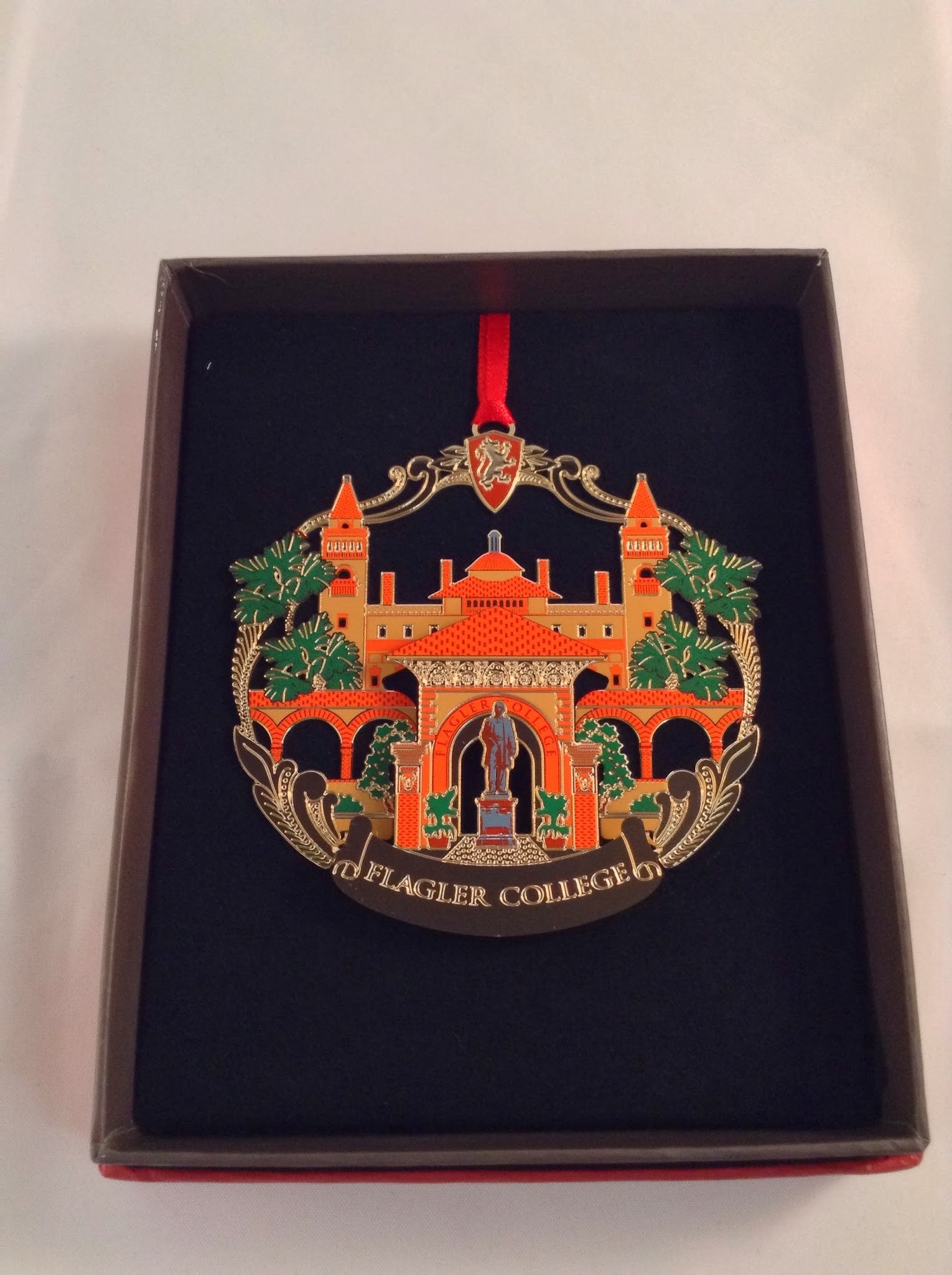 gold finished Flagler college building and Henry Flagler statue ornament
