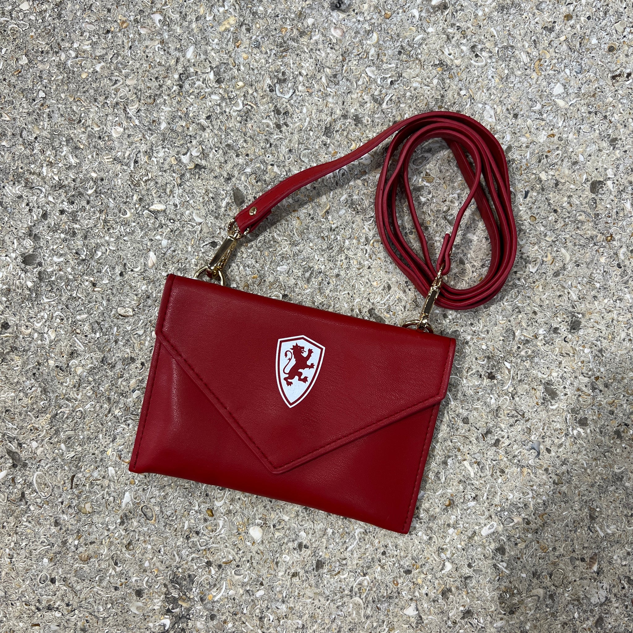 Crimson crossbody bag with white Flagler College Shield logo