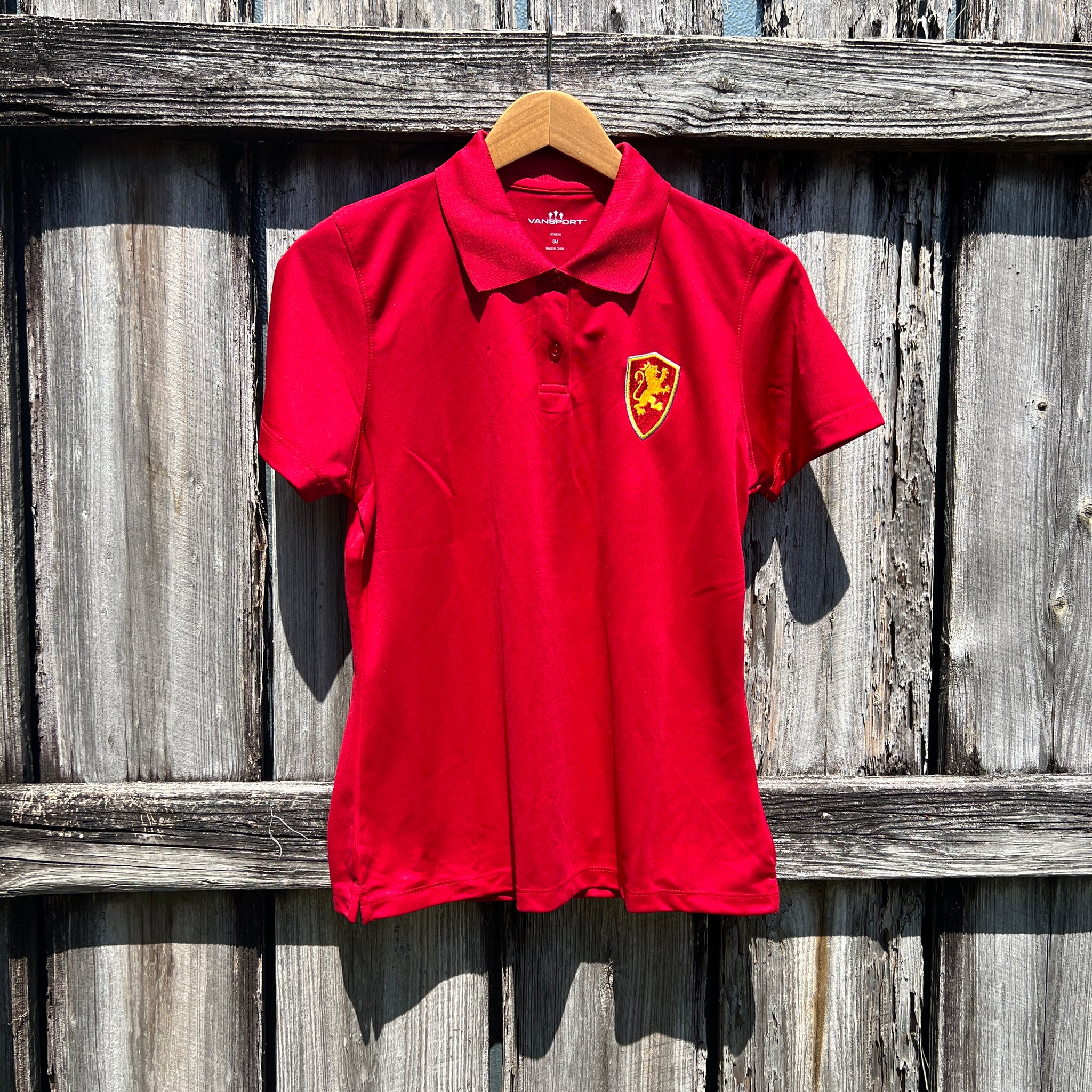 Women's Crimson collared polo with Flagler College shield logo on left side