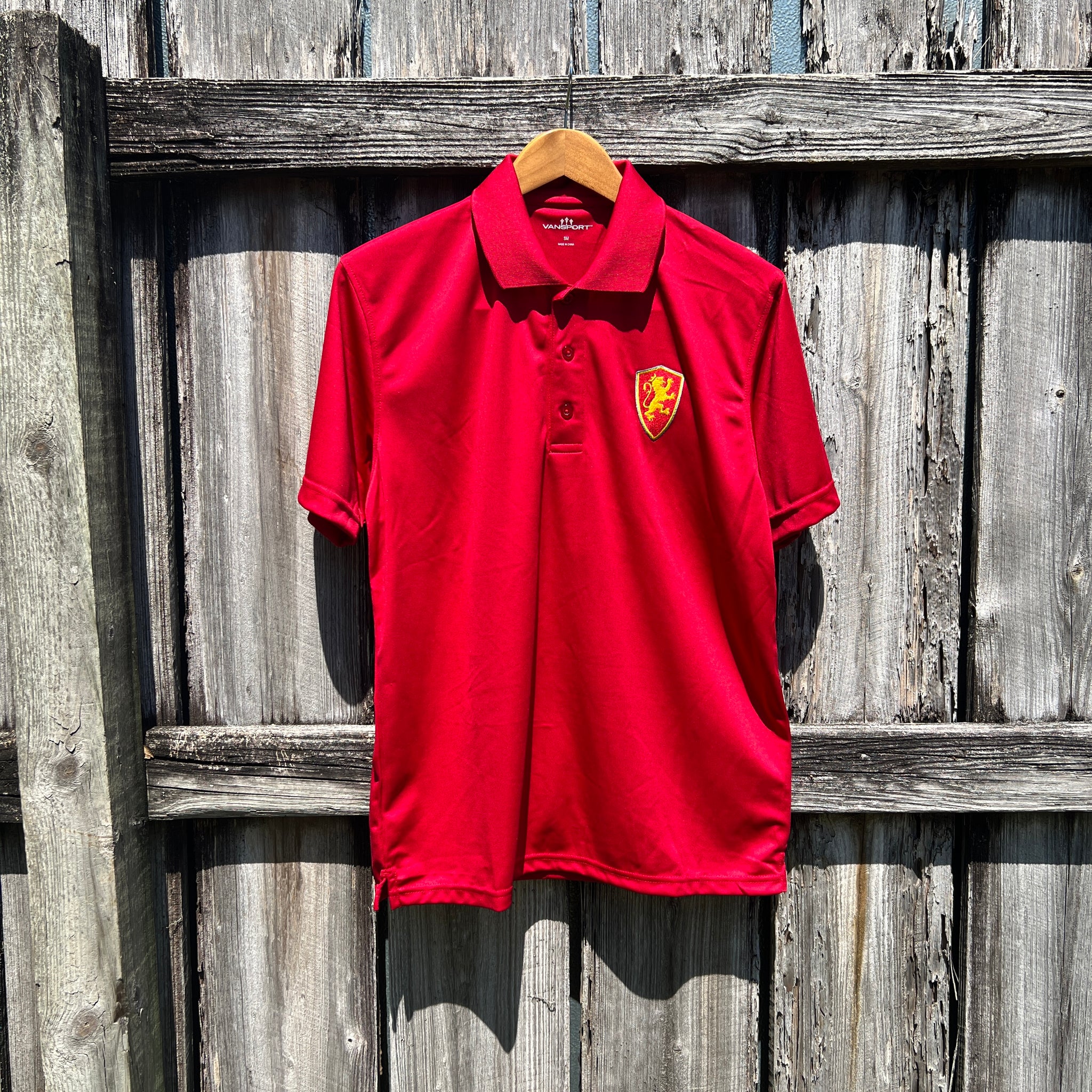 Men's Crimson collared polo with Flagler College shield logo on left side
