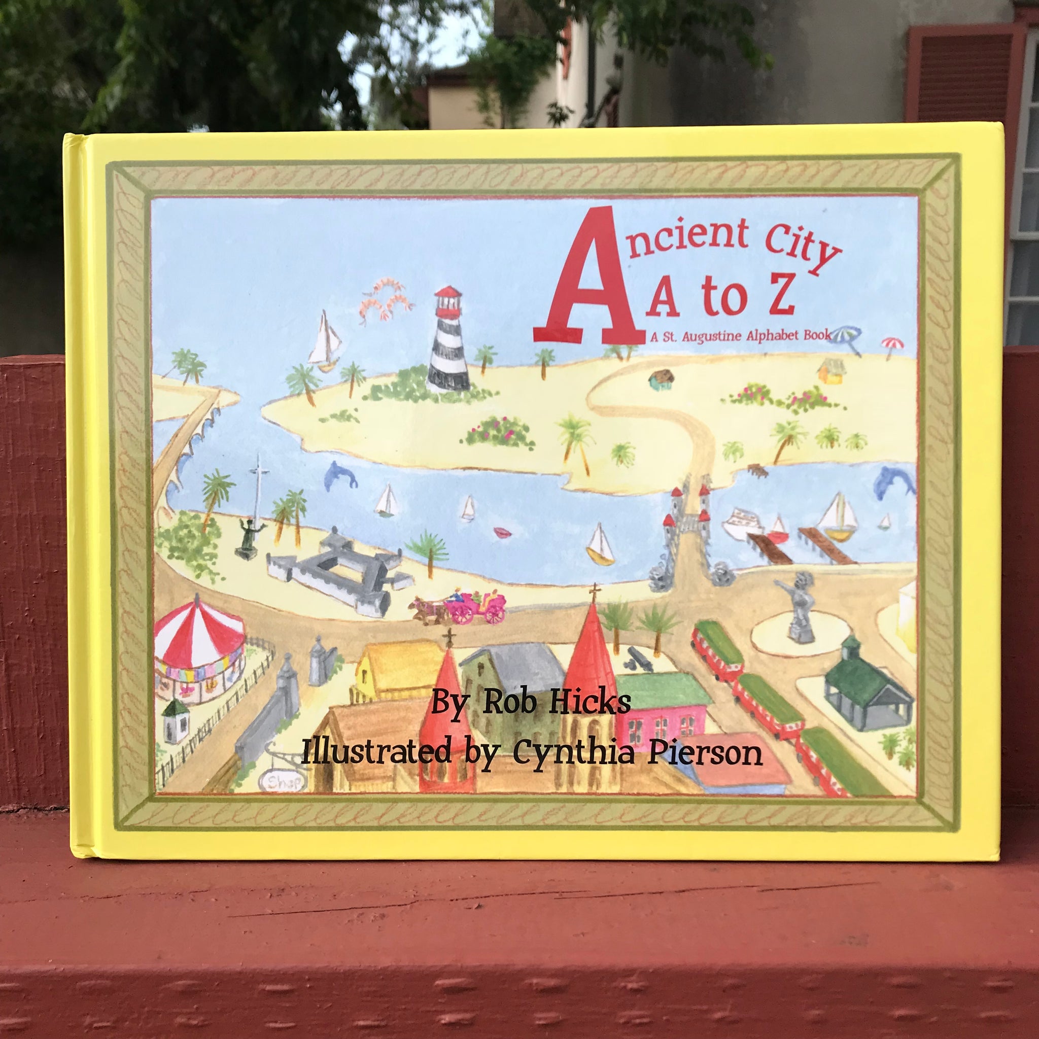 Illustrated overview of St Augustine and Anastasia island cover of book. Ancient City A to Z printed in red and author and illustrator printed in black