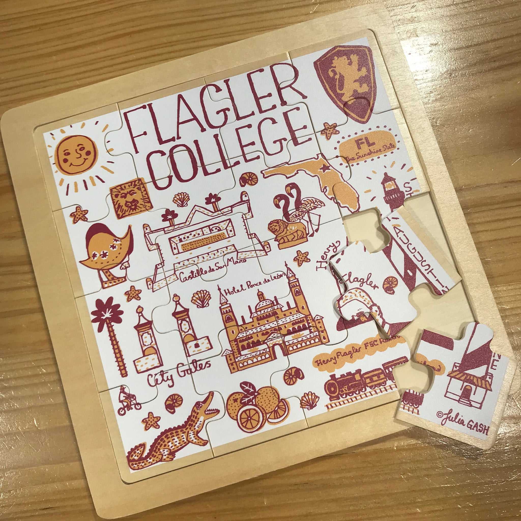 white wooden puzzle with  Julia Gash design including Flagler College, Henry Flagler, Castillo de San Marco, Alligator, etc