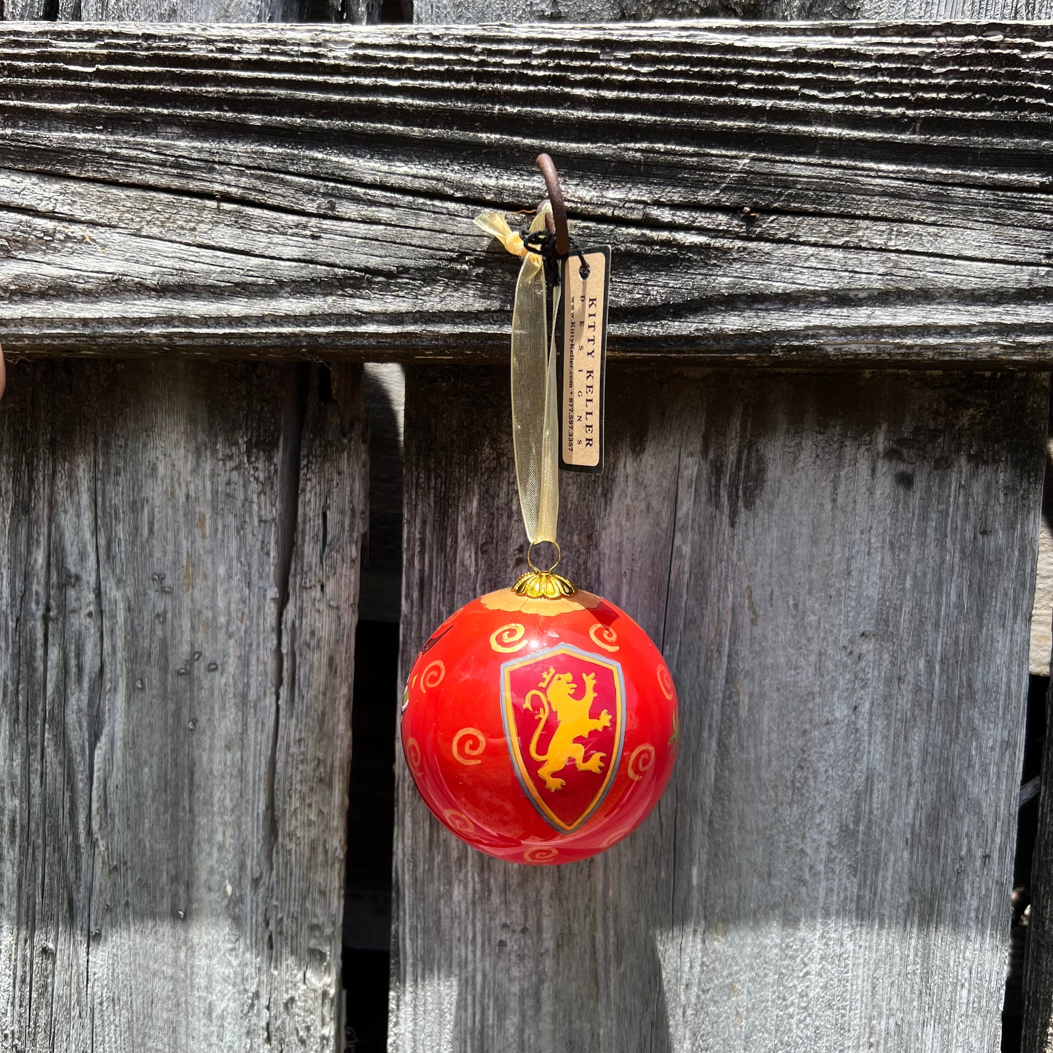 Red hand painted ornament with Flagler shield logo