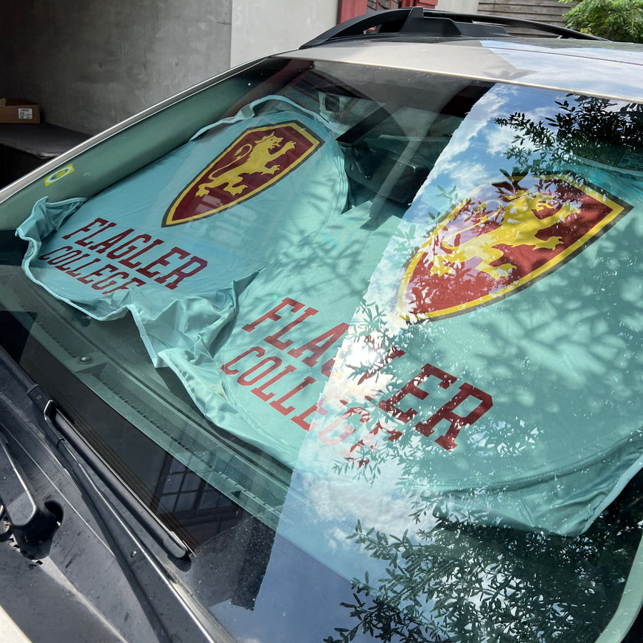 White windshield cover with Flagler College shield over crimson imprint saying Flagler over College on drivers side and passenger side of vehicle