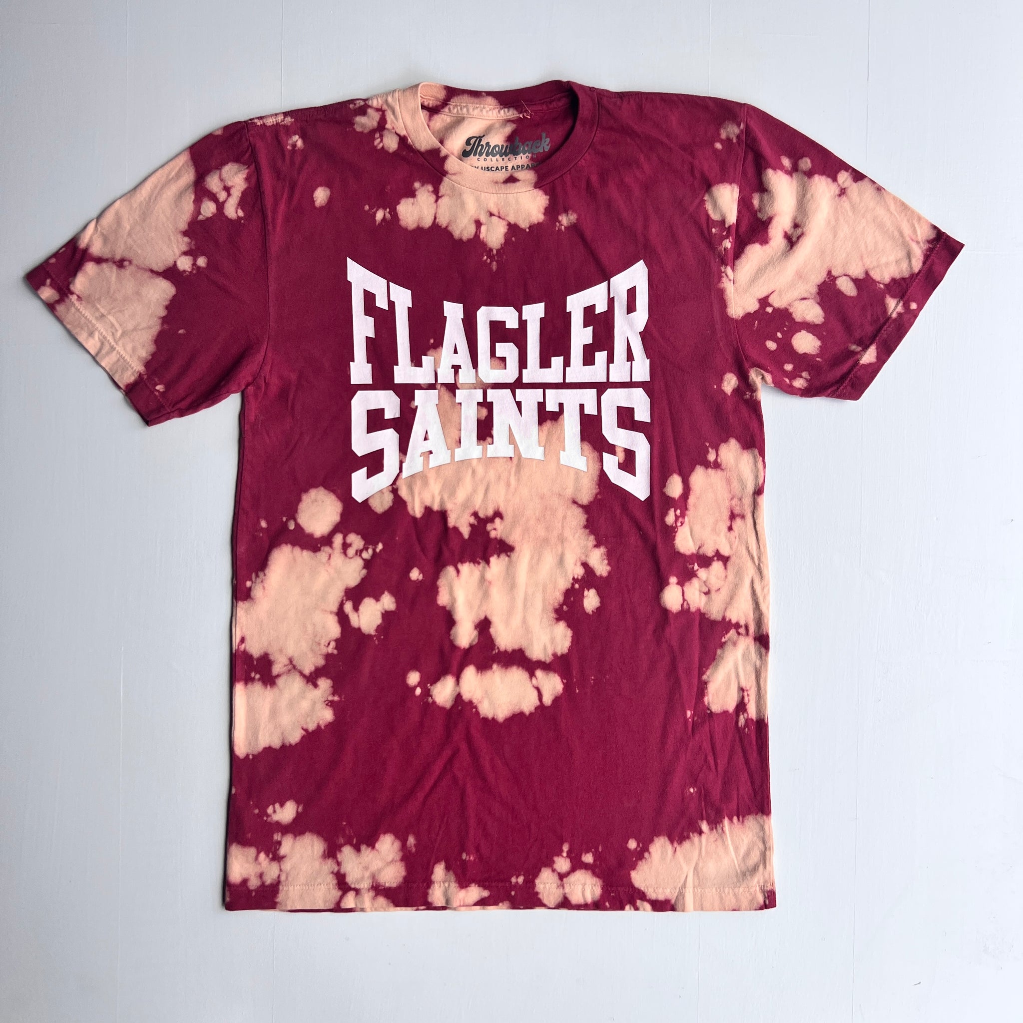 Crimson Bleach Washed with white imprint saying Flagler over Saints