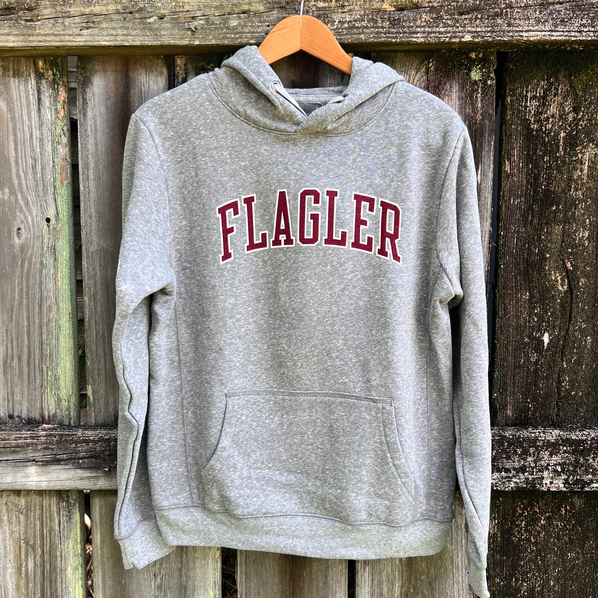 Grey hooded sweatshirt with crimson and white outline saying Flagler