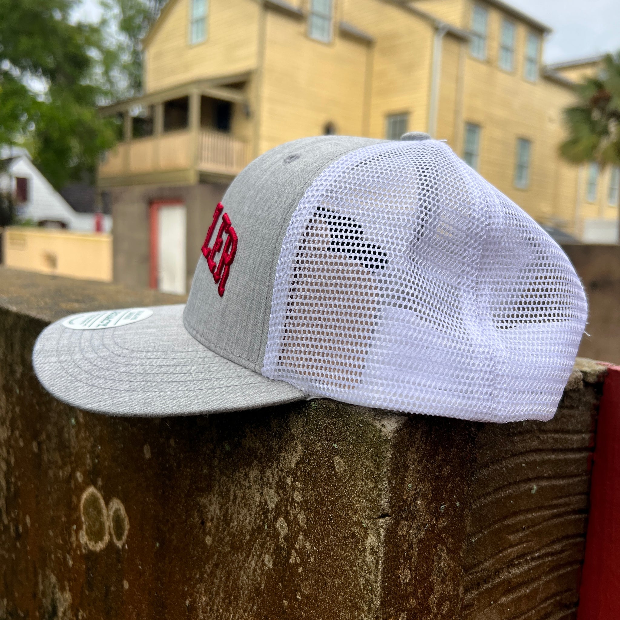 side picture of grey hat with white mesh back