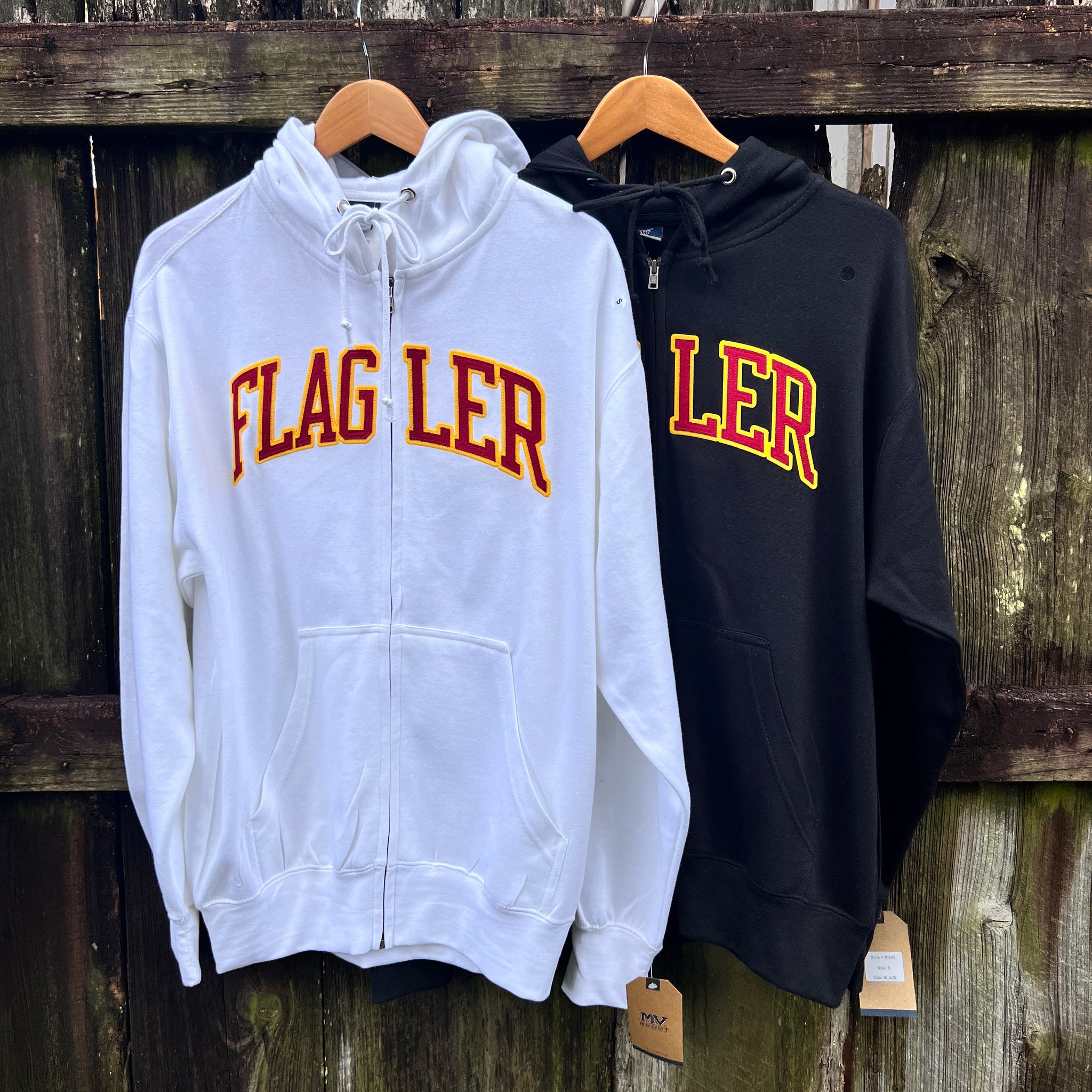 White and black full zip hood with crimson and gold imprint saying Flagler
