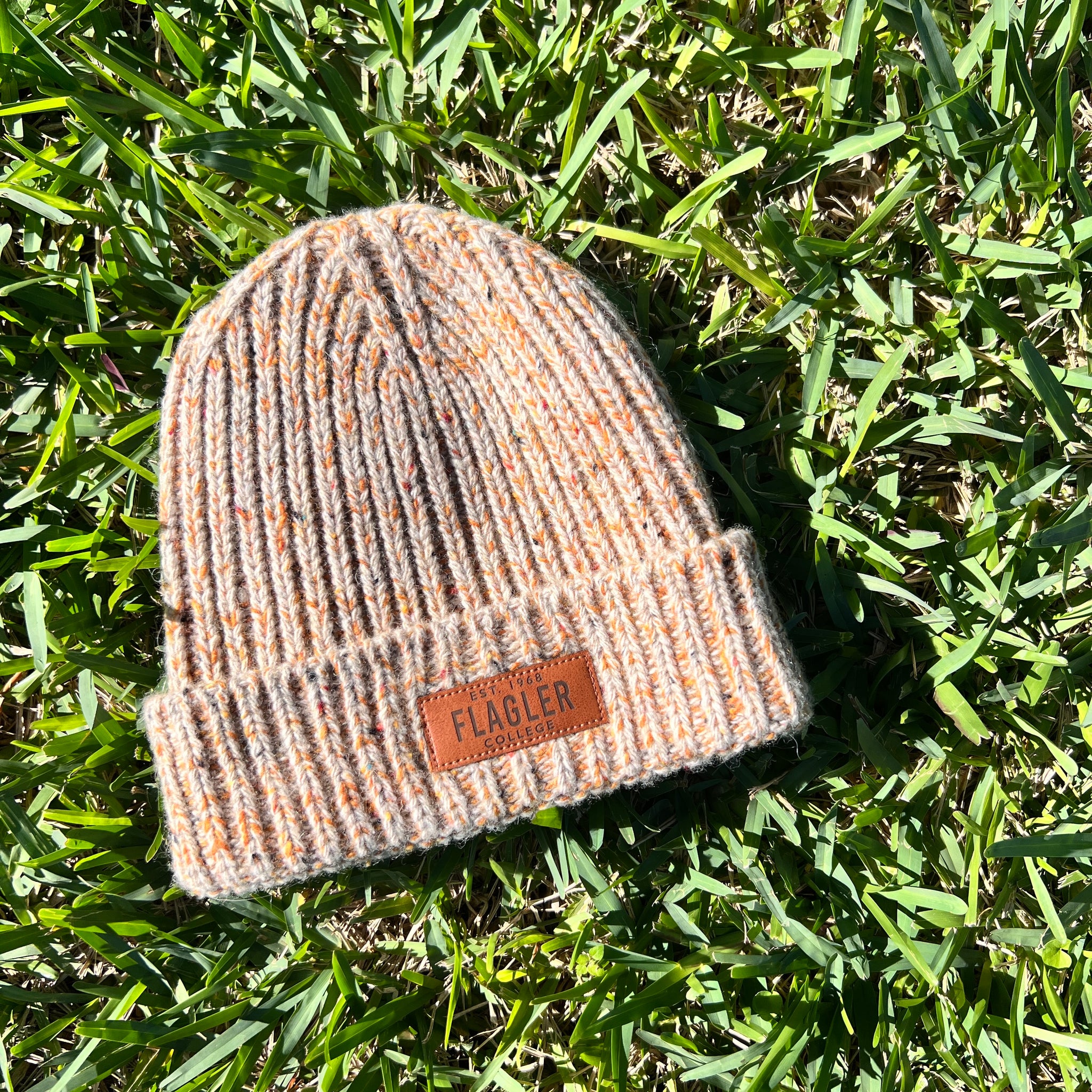Tan fleck beanie with patch on cuff saying est 1968 over Flagler over College