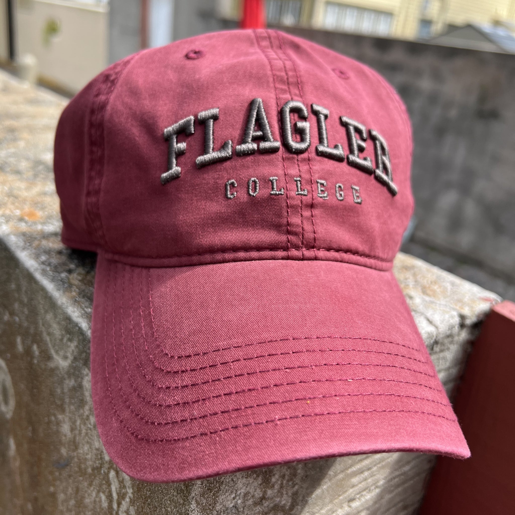 Crimson hat with charcola embroidering saying Flagler over College