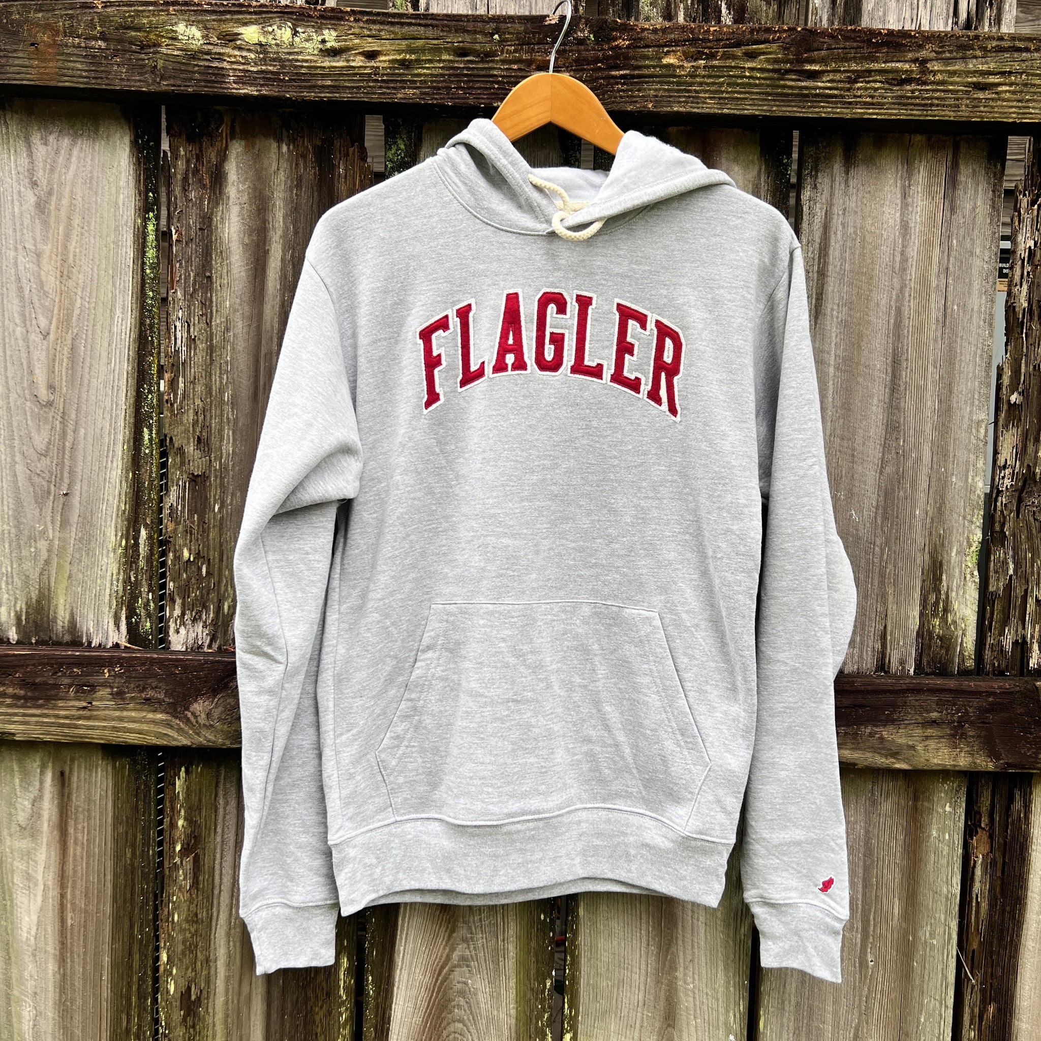 Oxford Grey hooded sweatshirt with arched crimson embroidering saying Flagler