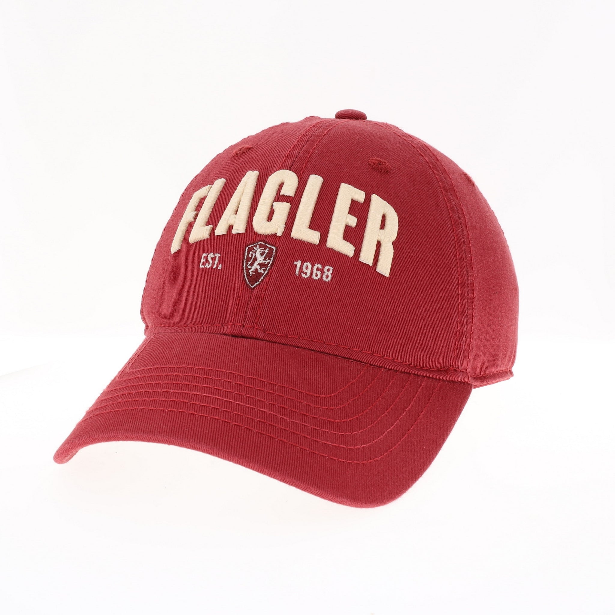 Red hat with white letters saying Flagler over white embroidr saying est. flagler college shield logo 1968