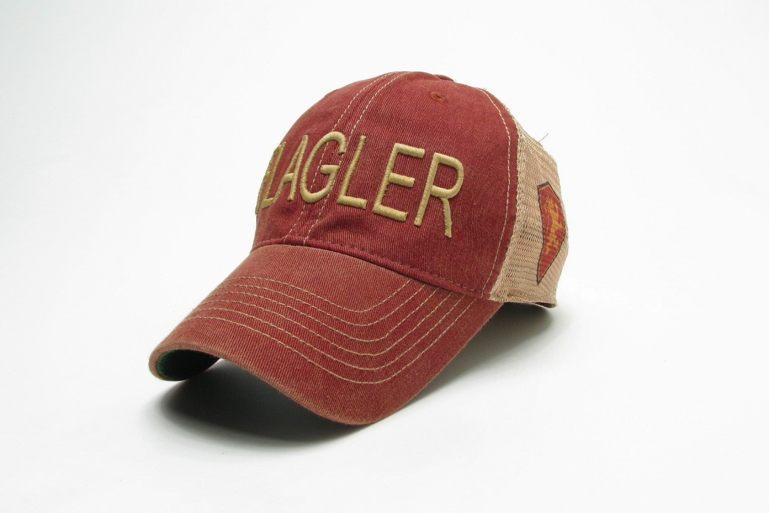 red hat with dirty effect with beige mesh back. Beige embroider saying Flagler and flagler college shield logo on the side of mesh