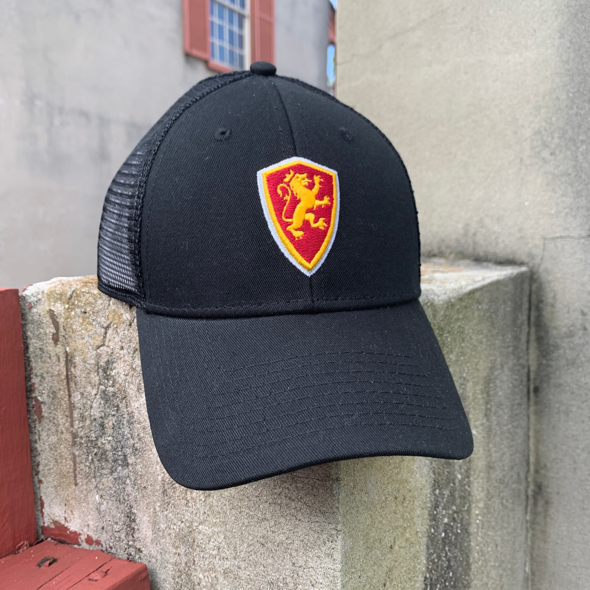 Black hat with mesh back with Flagler shield logo in middle