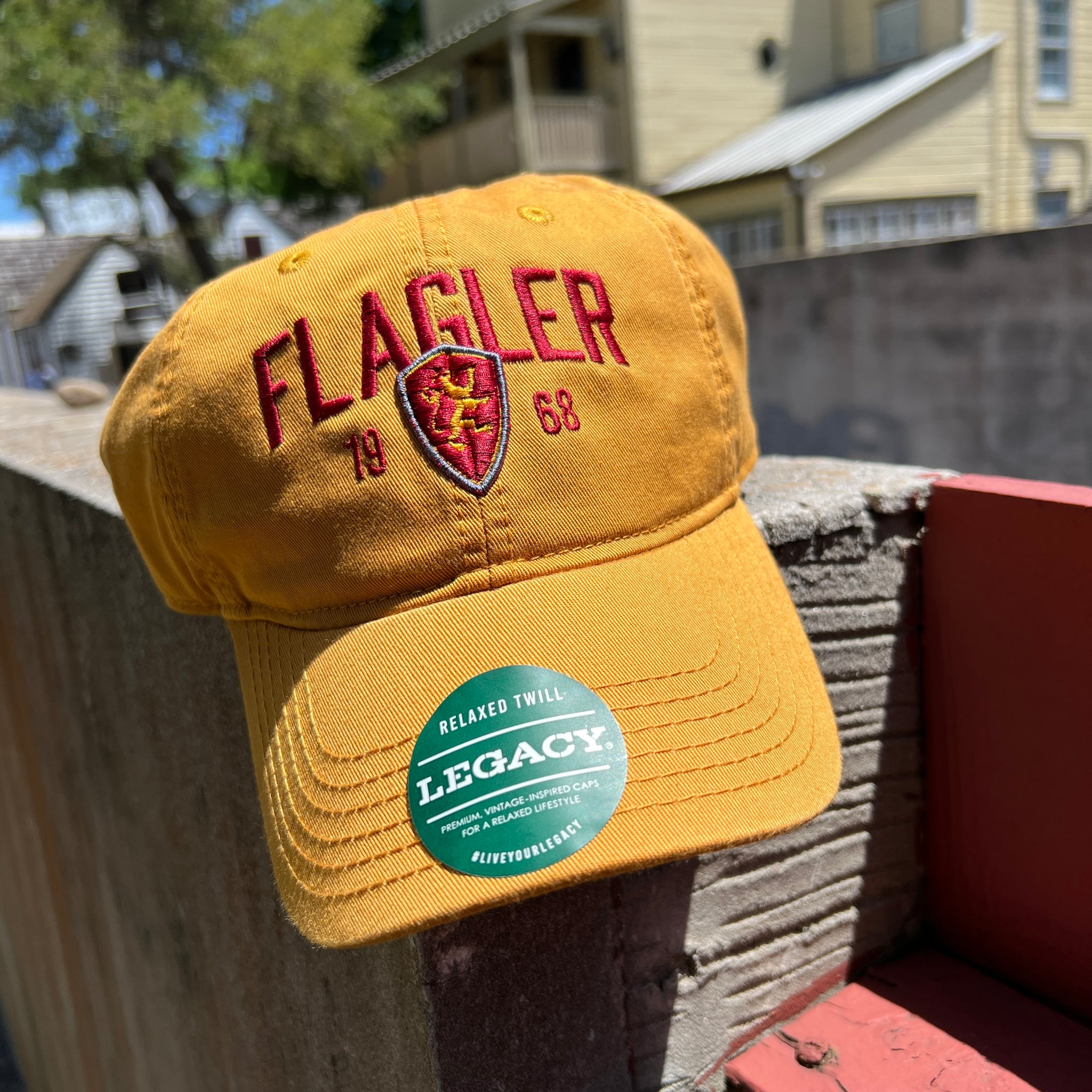 gold hat with red letters saying Flagler over 19 flagler college shield logo 68