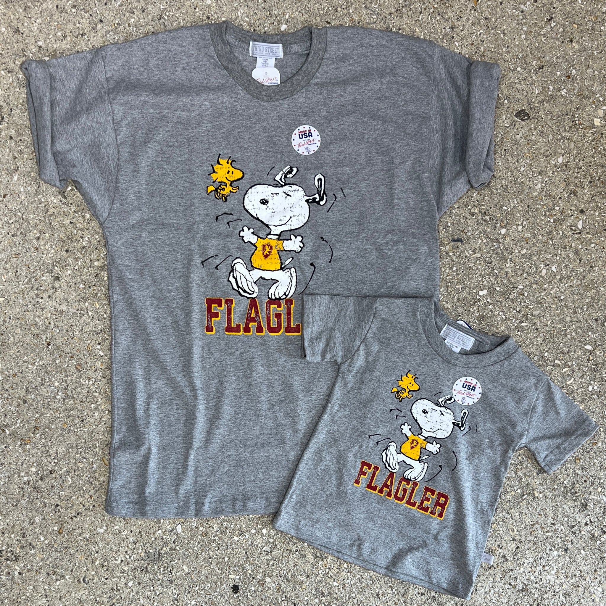 2 grey t-shirts with woodstock and snoopy over crimson imprint saying Flagler