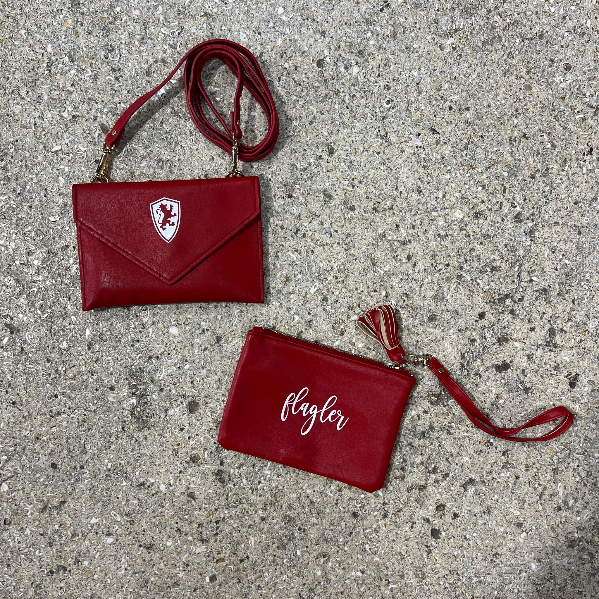 Crimson wristlet bag with white cursive imprint saying Flagler