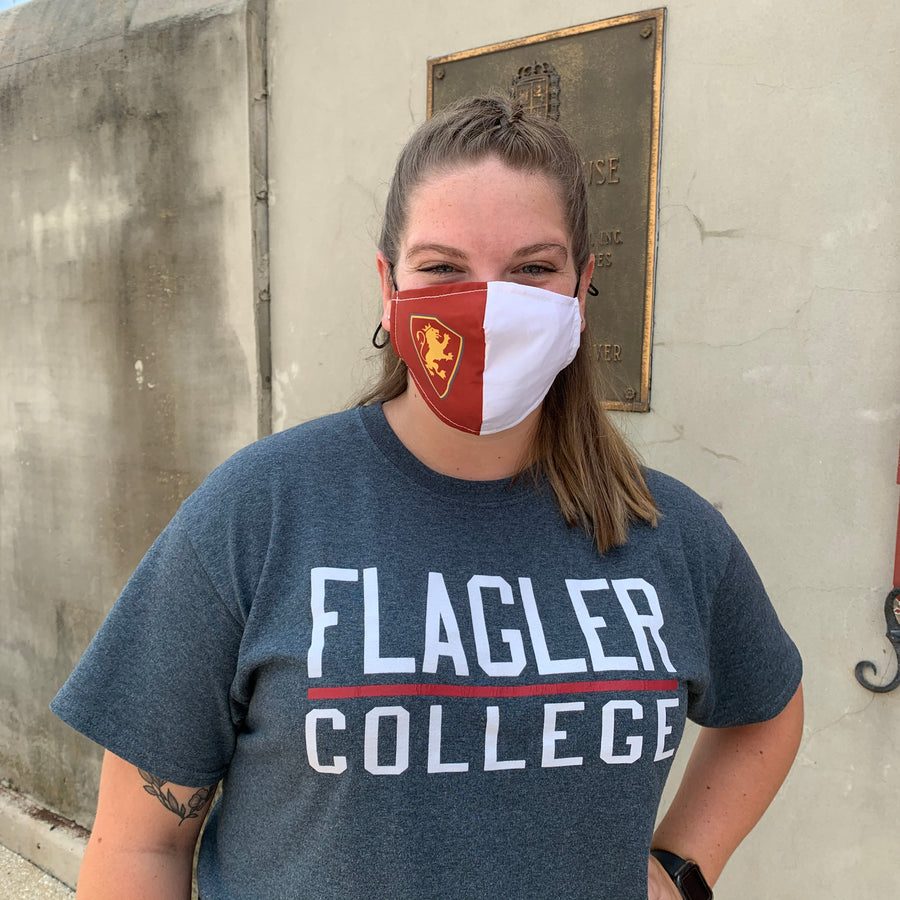 woman wearing face mask. Crimson on right side with Flagler College Shield Logo and white on left