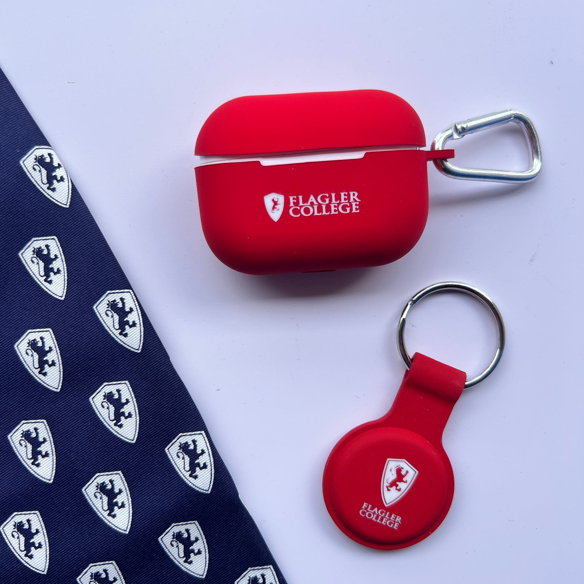 red silicone air tag holder with white imprint of Flagler Shield logo over Flagler over College