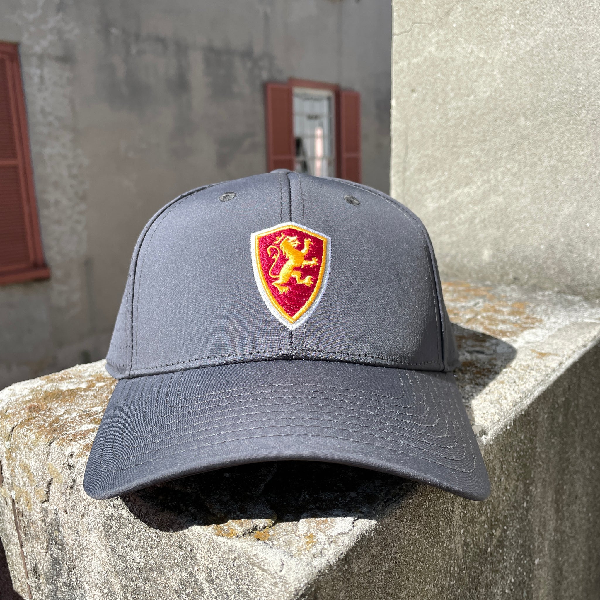 Grey hat with side perforations and Flagler College shield logo in middle