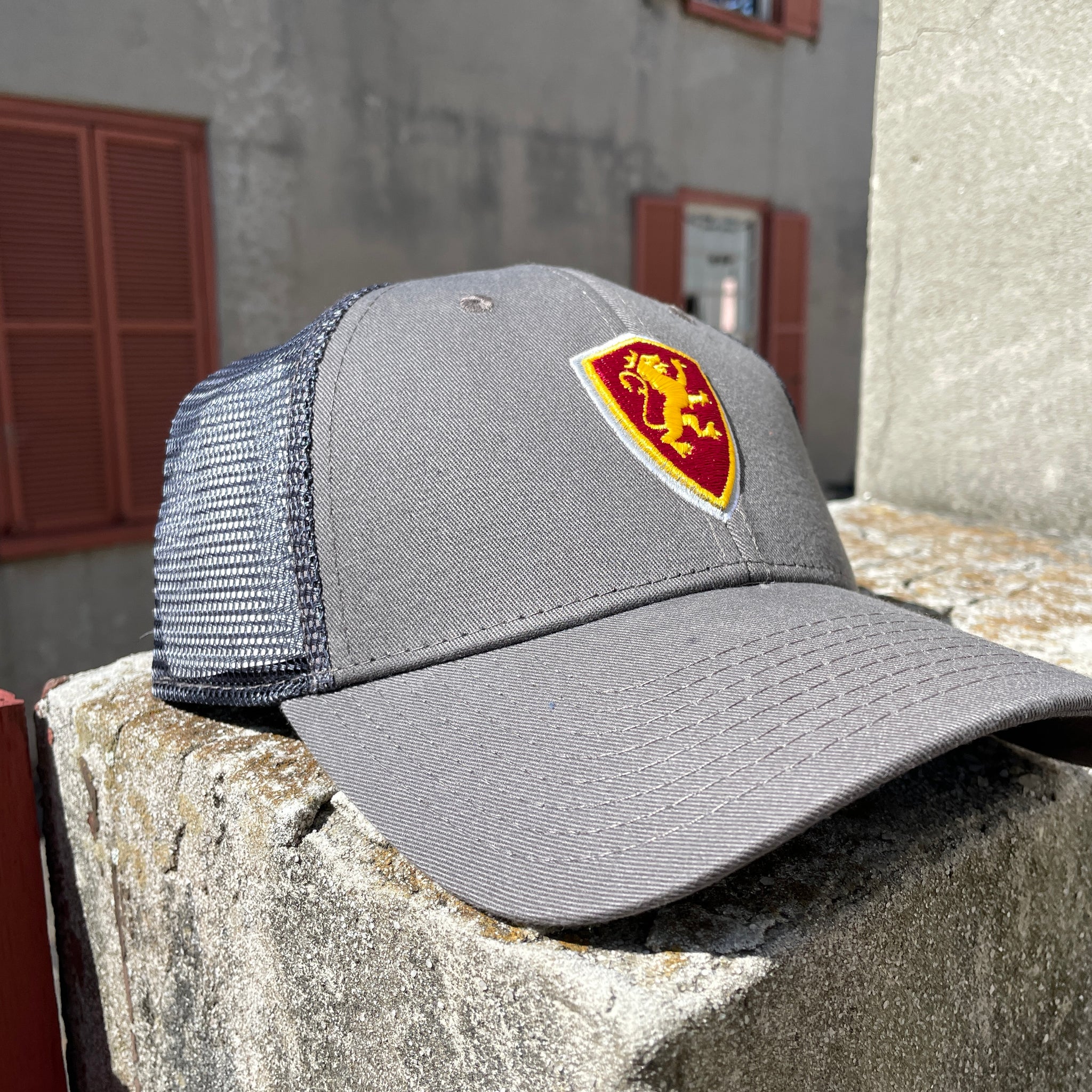 Grey hat with mesh back with Flagler shield logo in middle