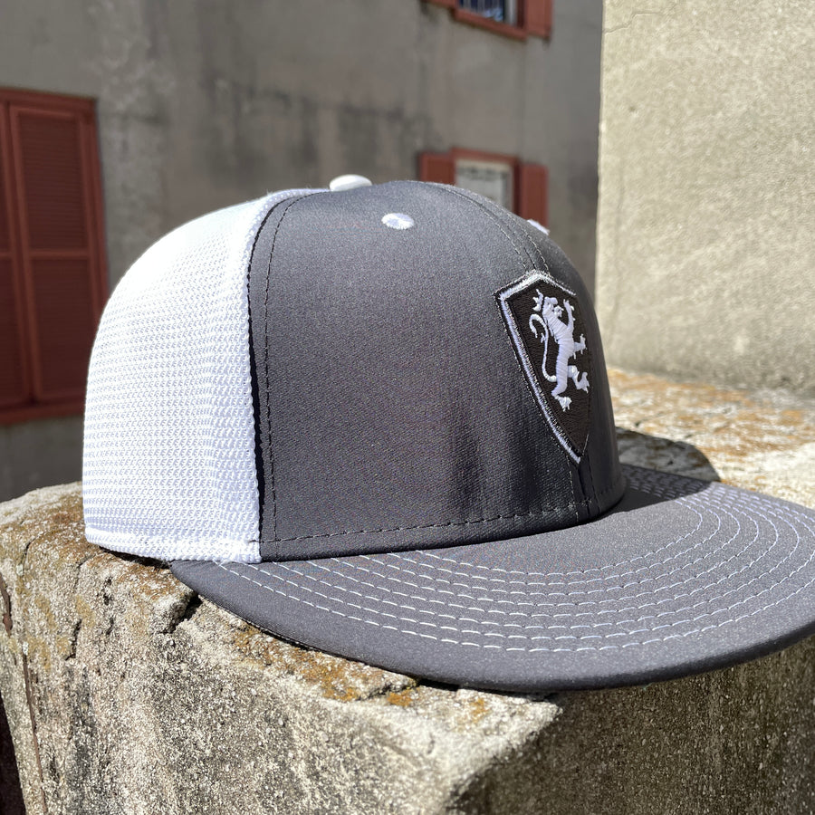 grey hat with black and white flagler college shield logo with white mesh back