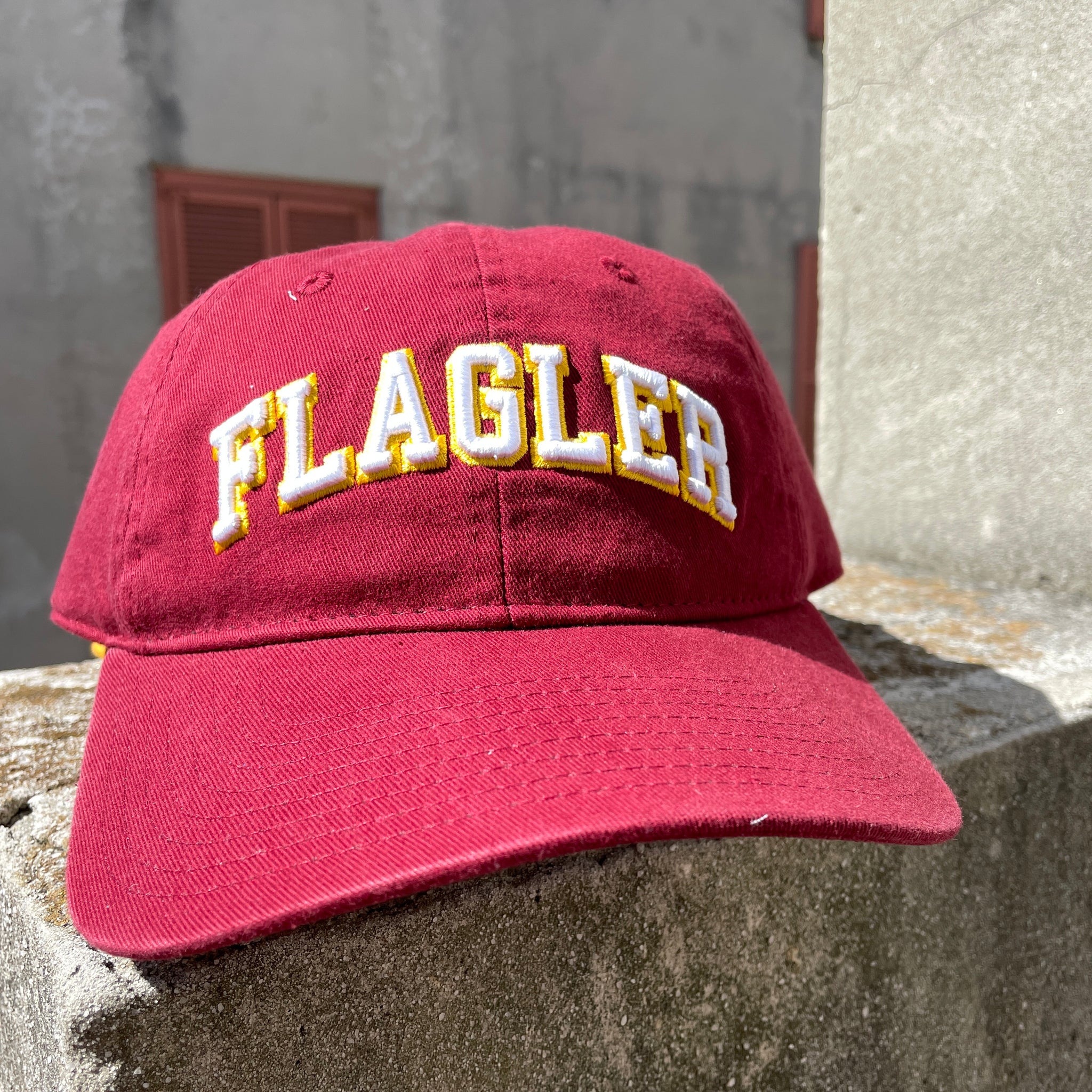  Crimson hat with white letters saying Flagler. 