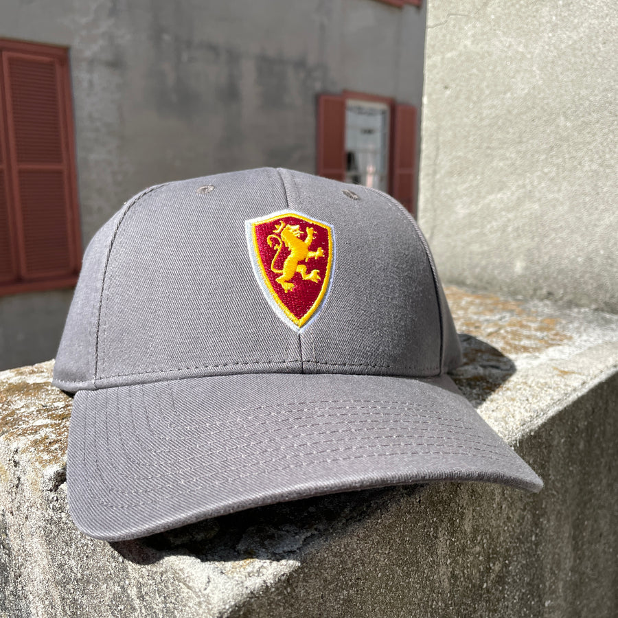 White and grey hats with Flagler College Shield Logo in center 