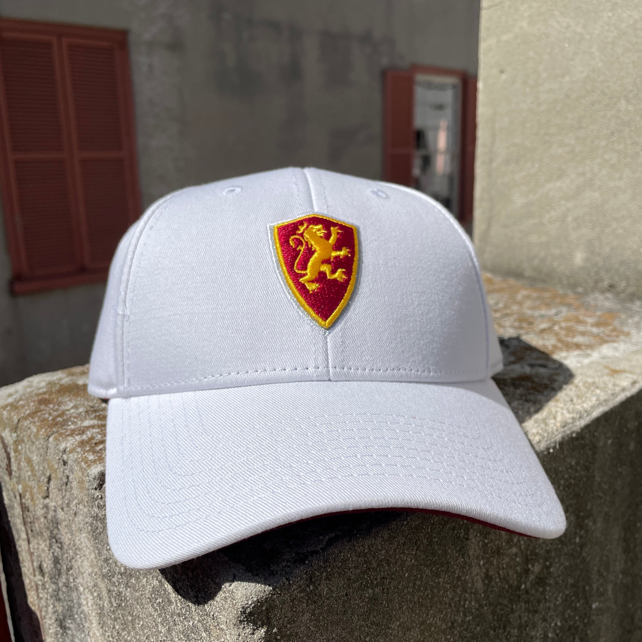 White hat with Flagler College Shield Logo in center