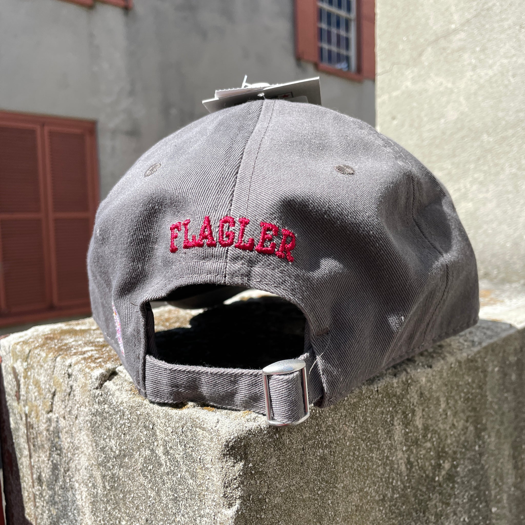Back of grey hat with crimson embroidering saying Flagler