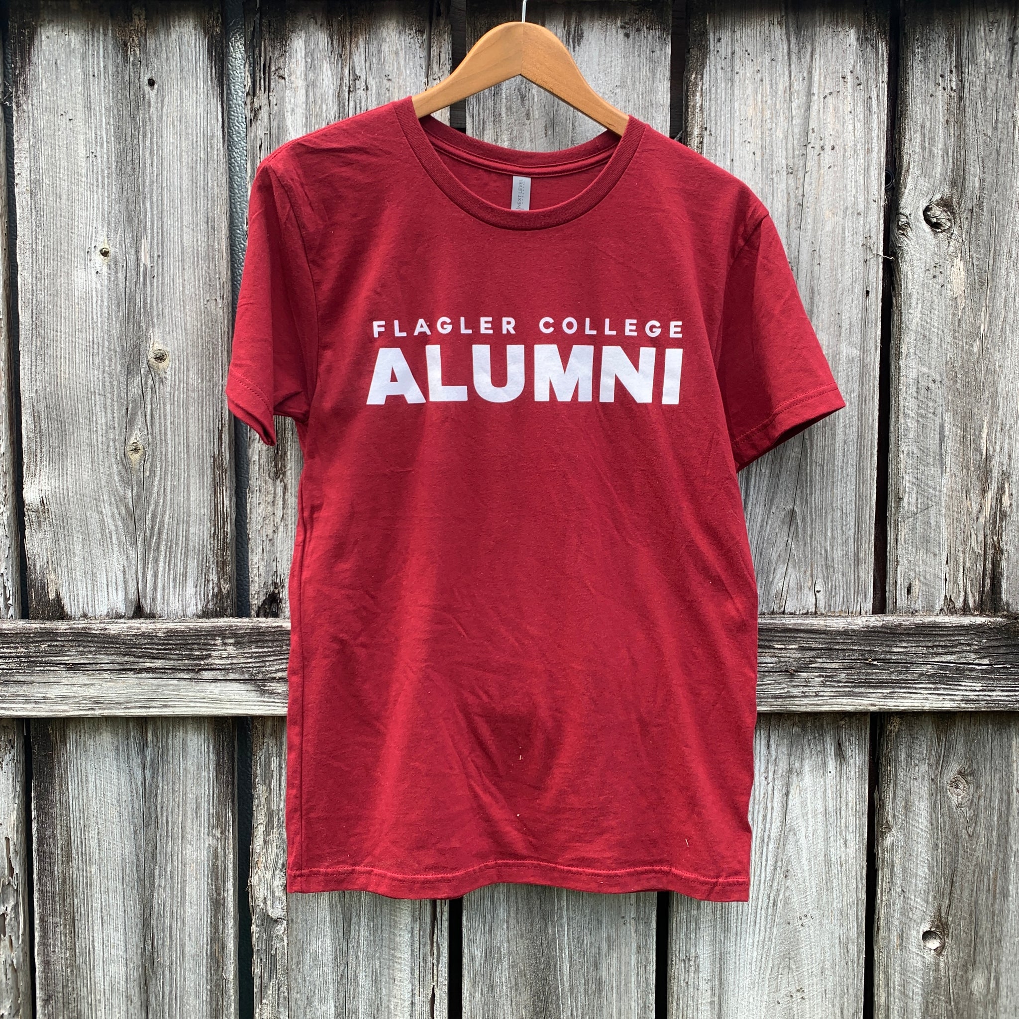 Crimson t-shirt white imprint saying Flagler College Alumni