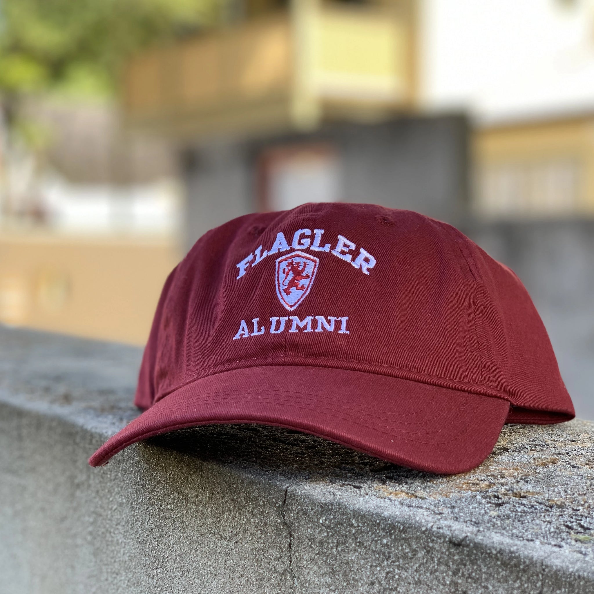 red hat with a shield and Flagler Alumni embroidered in white