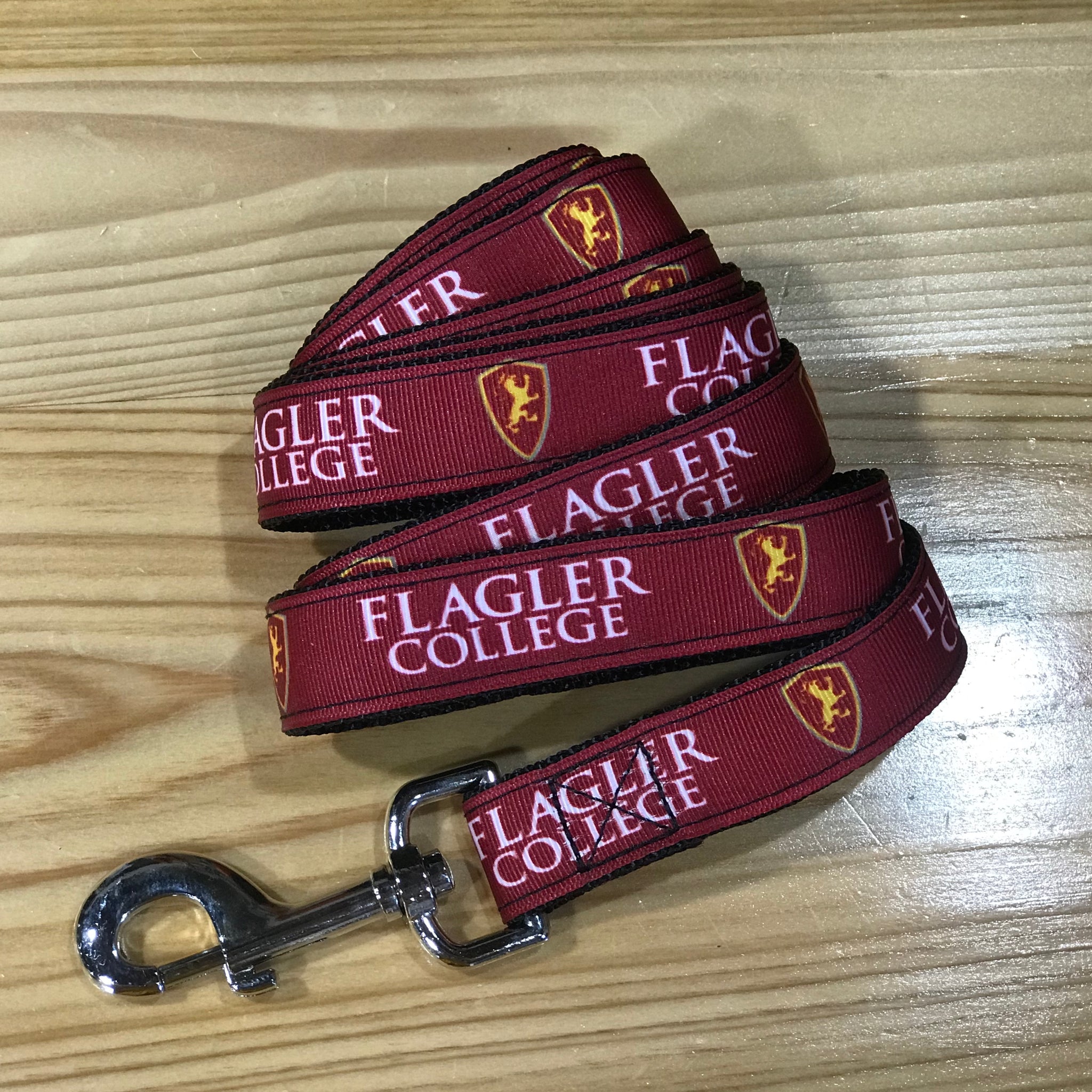 red dog leash with Flagler college printed in white and shield printed in red and yellow