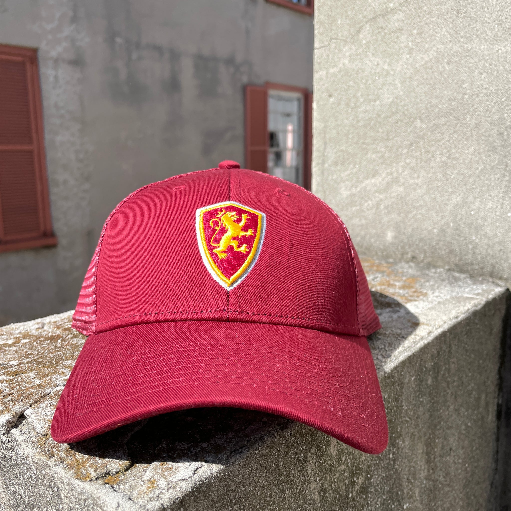red hat with mesh back with Flagler shield logo in middle
