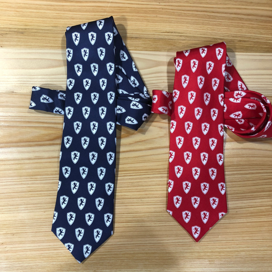 2 silk ties rolled up. dark blue with white Flagler college shield logos and crimson red with white Flagler college shield logos