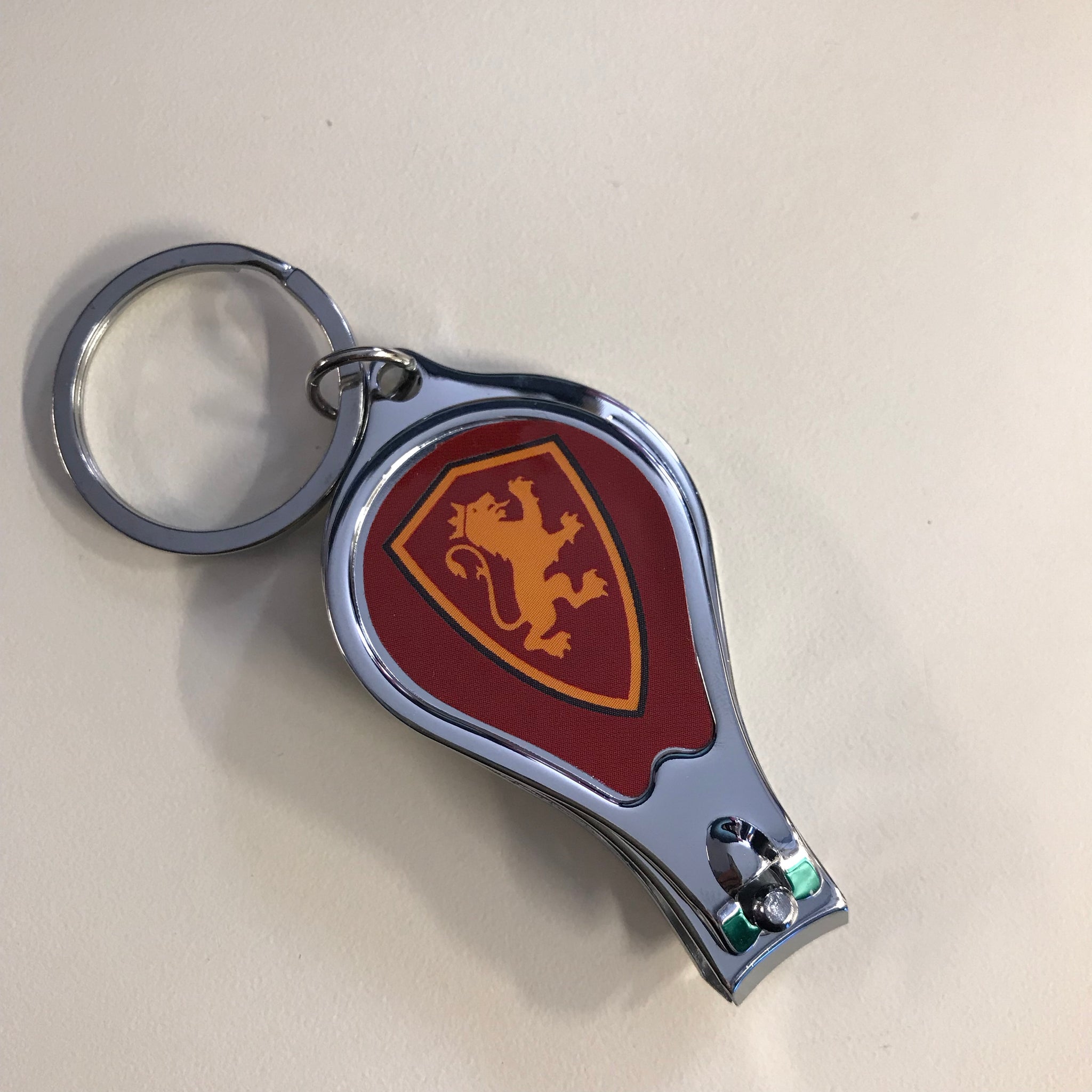 red and gold shield printed on nail clippers
